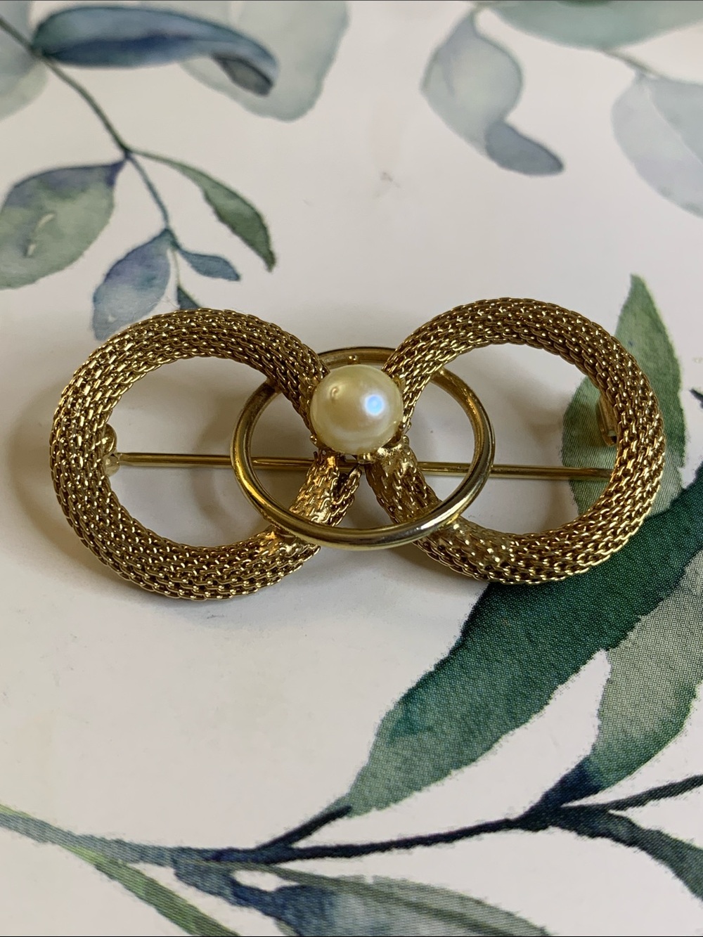 Gold Tone Three Circled Brooch with White Faux Pearl.